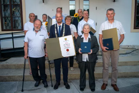 Leto&scaron;nji občinski nagrajenci z županom Tinetom Radinjo. Priznanje za časnega občana sta v imenu sina Jana prevzela mama in oče Stojanka in Matjaž Oblak. / Foto: Primož Pičulin
